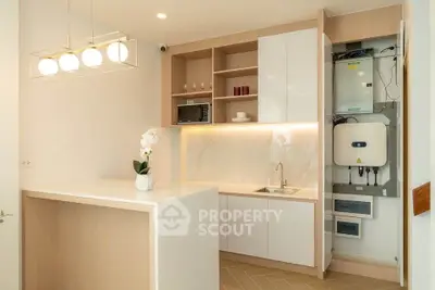 Modern kitchen with sleek cabinetry and integrated appliances in a stylish apartment.