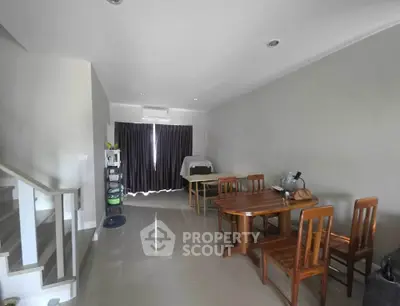 Spacious living room with modern furniture and natural light, perfect for family gatherings.