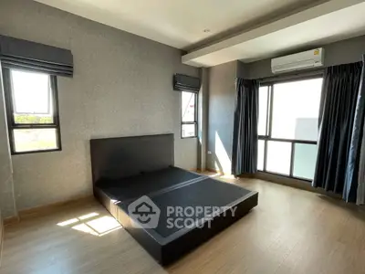 Spacious bedroom with modern design and large windows for natural light