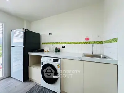 Modern kitchen with sleek appliances and stylish backsplash
