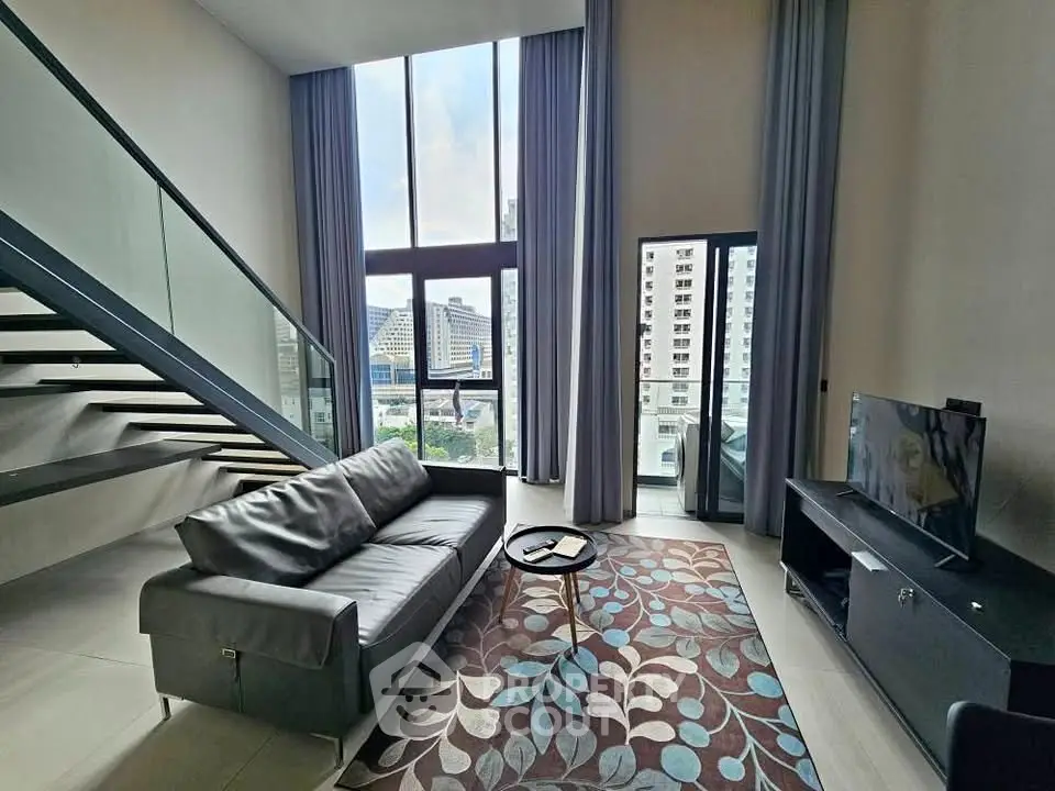 Spacious modern living room with high ceilings and large windows offering city views.