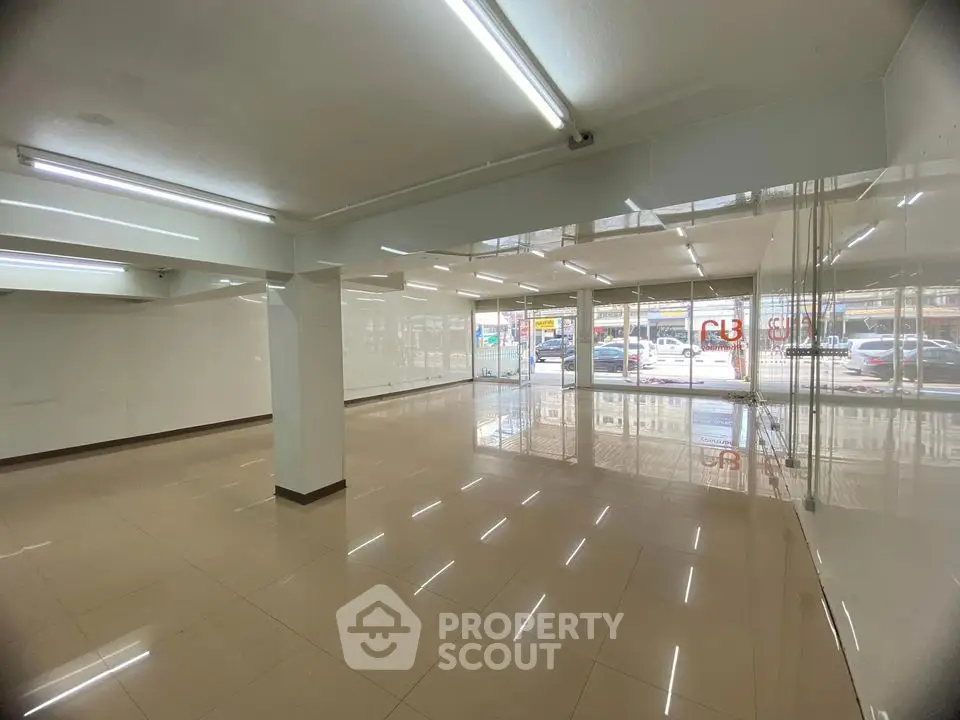 Spacious commercial property with large windows and tiled flooring in prime location.