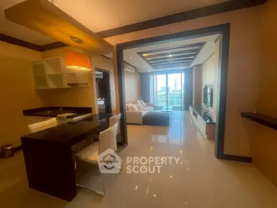 Modern open-plan living room with city view, sleek kitchen, and stylish decor in urban apartment.