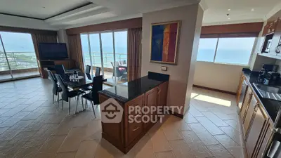 Spacious open-layout living room with ocean view and modern kitchen