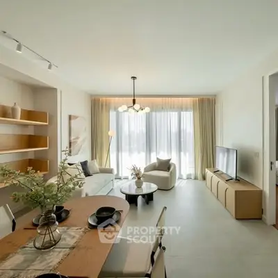 Modern living room with elegant decor and natural light, featuring a cozy seating area and stylish dining table.