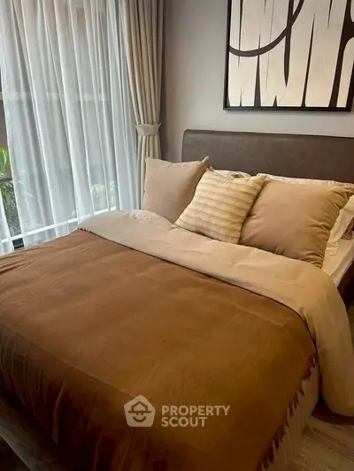 Cozy bedroom with elegant decor and large window for natural light