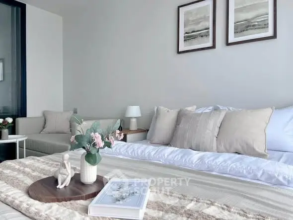 Elegant bedroom with neutral decor and stylish artwork, perfect for relaxation.