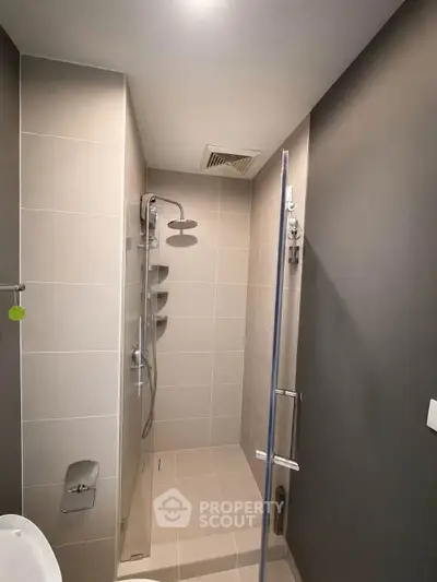 Modern bathroom with sleek shower design and neutral tiles