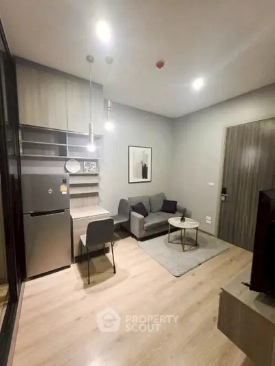 Modern living room with sleek furniture and open kitchen layout