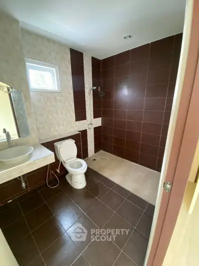 Modern bathroom with sleek tiles and walk-in shower design