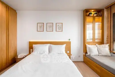 Modern bedroom with wooden accents, cozy window seat, and elegant decor