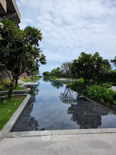 Luxurious garden view with serene water feature and lush greenery