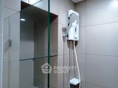 Modern bathroom with sleek shower unit and glass partition