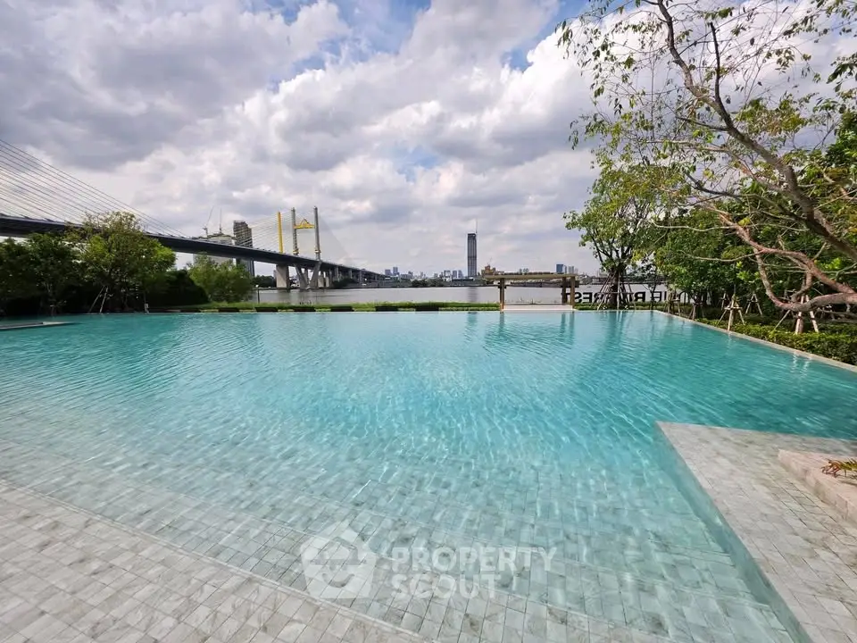 Luxurious infinity pool with stunning city skyline and bridge view, perfect for relaxation and leisure.