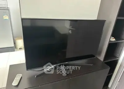 Modern living room with sleek TV setup and contemporary furniture.