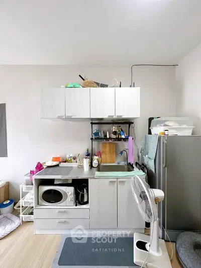 Compact kitchen with modern appliances and storage solutions