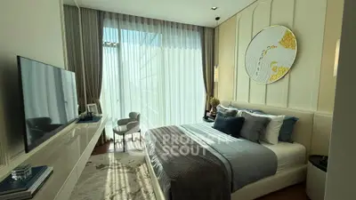 Luxurious bedroom with elegant decor and large window offering natural light.