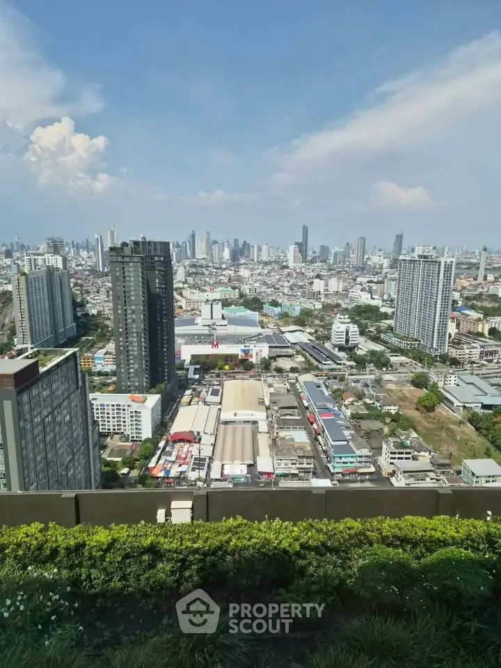 Stunning cityscape view from a high-rise building showcasing urban skyline and greenery.
