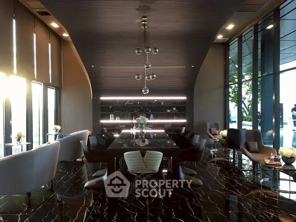 Luxurious modern dining area with sleek black marble flooring and elegant lighting.