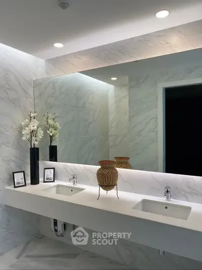 Luxurious modern bathroom with dual sinks and elegant decor