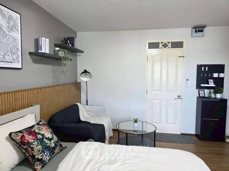 Modern bedroom with stylish decor, featuring a cozy bed, elegant lighting, and a chic seating area.