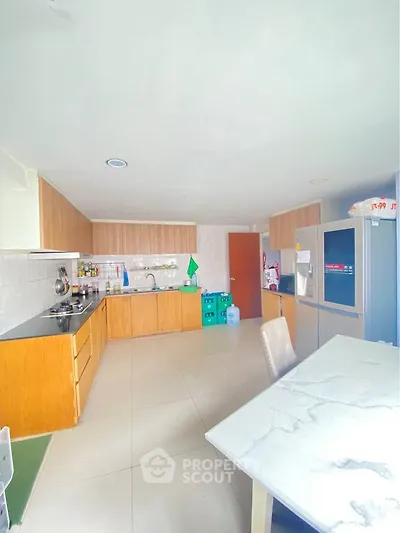 Spacious kitchen with modern appliances and sleek cabinetry