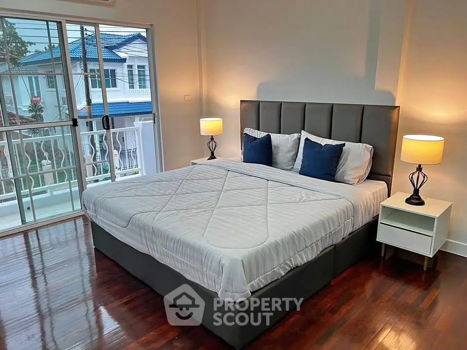 Spacious bedroom with elegant decor and balcony access in modern home