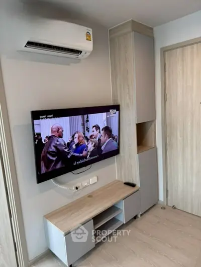 Modern living room with wall-mounted TV and sleek air conditioning unit