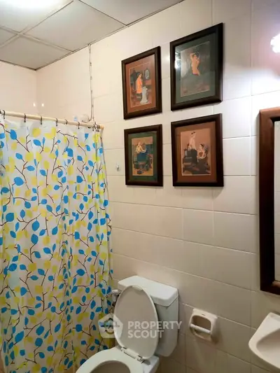 Charming bathroom with artistic decor and vibrant shower curtain