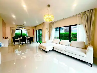 Spacious modern living room with elegant dining area and large windows for natural light.
