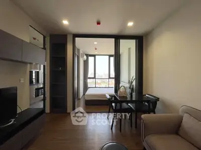 Modern apartment interior with cozy living room and bedroom view, featuring sleek furniture and cityscape backdrop.