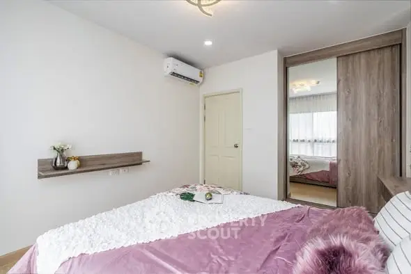 Cozy bedroom with modern decor and ample natural light