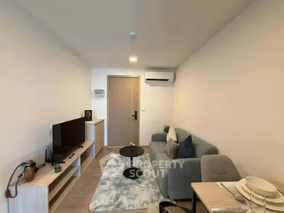 Modern living room with cozy sofa, TV, and dining area in stylish apartment.