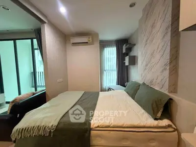 Modern bedroom with stylish decor and large window in a contemporary apartment.