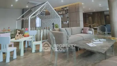Luxurious living room with modern decor and playful children's area, perfect for family gatherings.