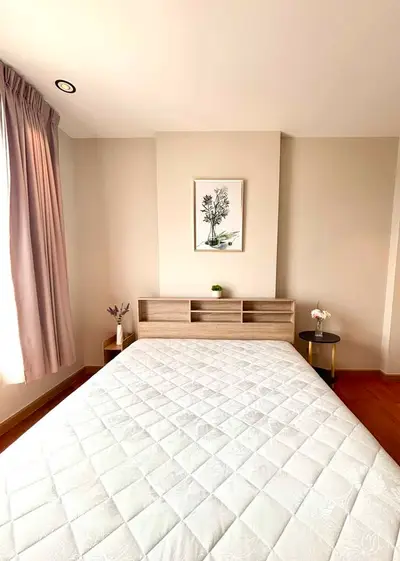 Cozy bedroom with elegant decor and natural light, featuring a comfortable bed and stylish furnishings.
