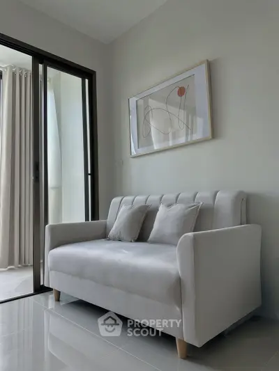 Modern living room with sleek sofa and abstract art, perfect for stylish urban living.