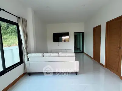 Spacious living room with modern decor and large window view