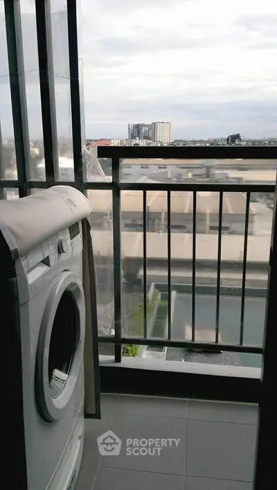 Modern apartment balcony with washing machine and city view