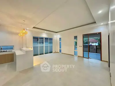 Spacious modern living room with open layout and elegant lighting