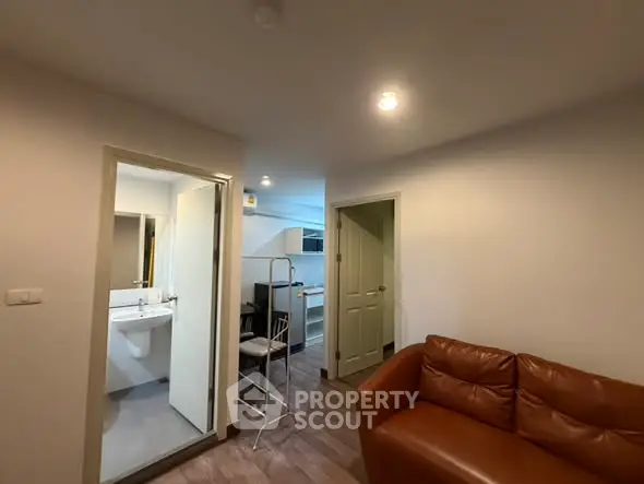 Cozy apartment interior with leather sofa and modern bathroom