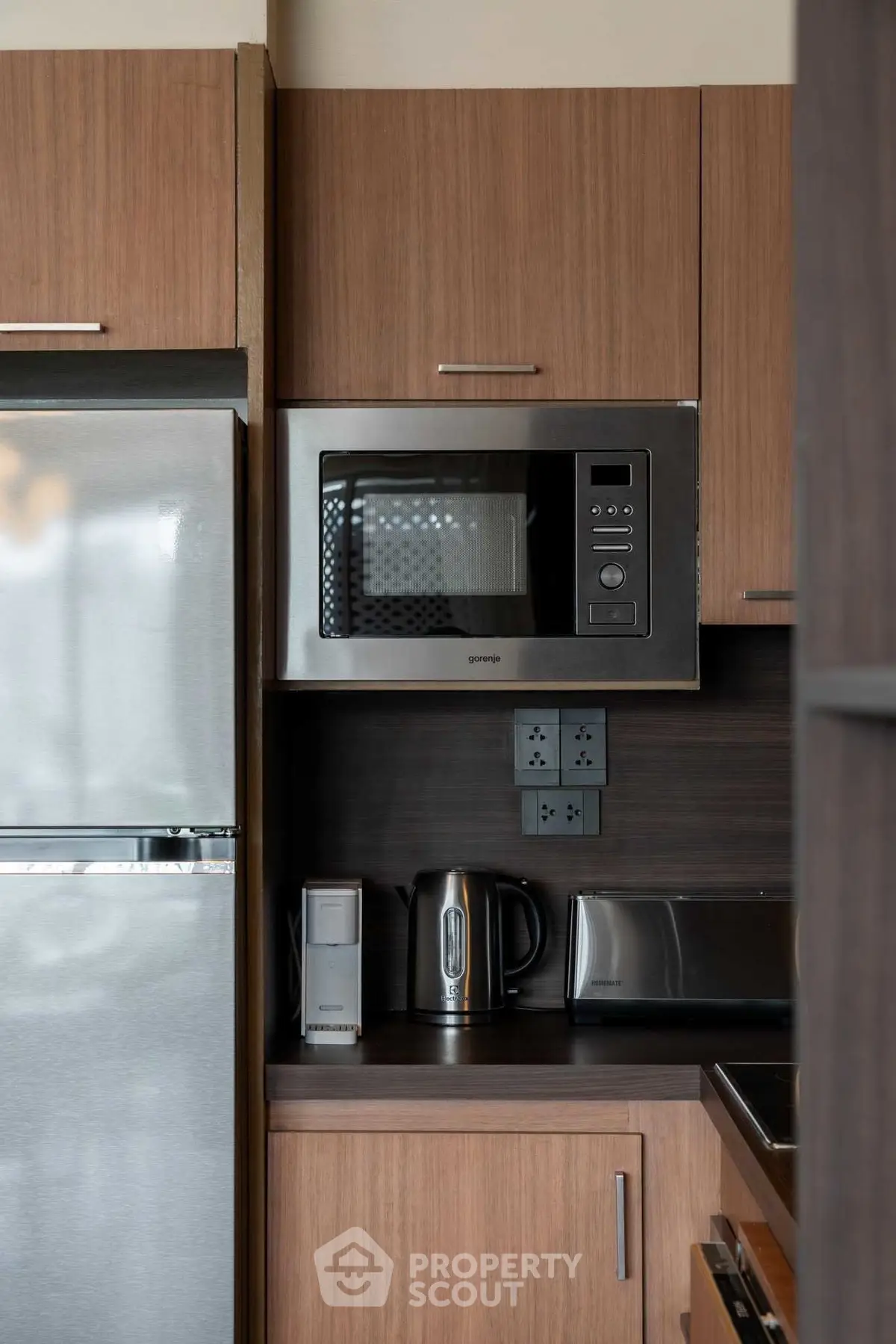 Modern kitchen with stainless steel appliances and sleek wooden cabinetry