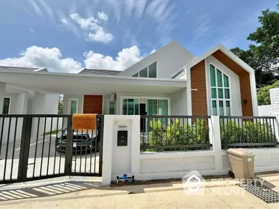 Modern single-story house with sleek design and spacious driveway in a serene neighborhood.