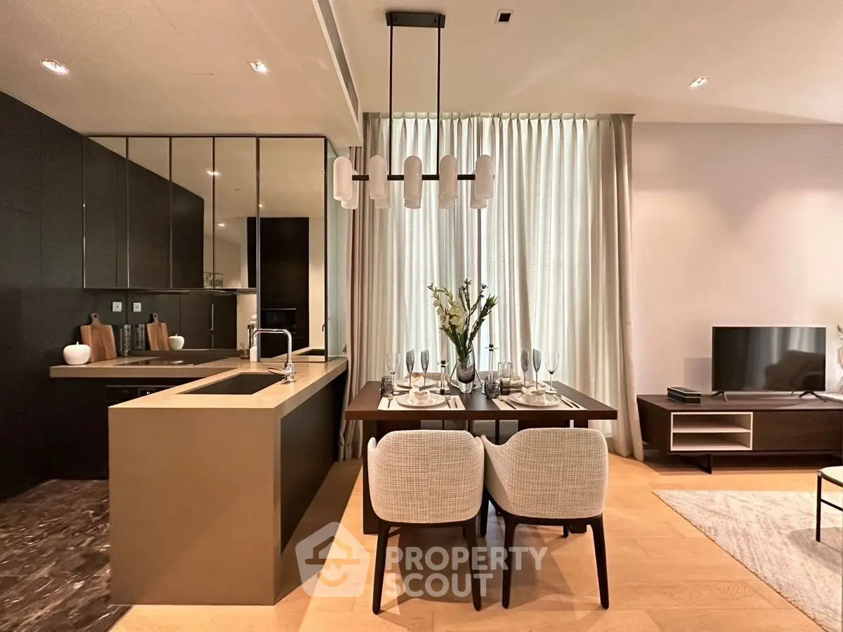 Modern open-plan kitchen and dining area with elegant decor and natural light.