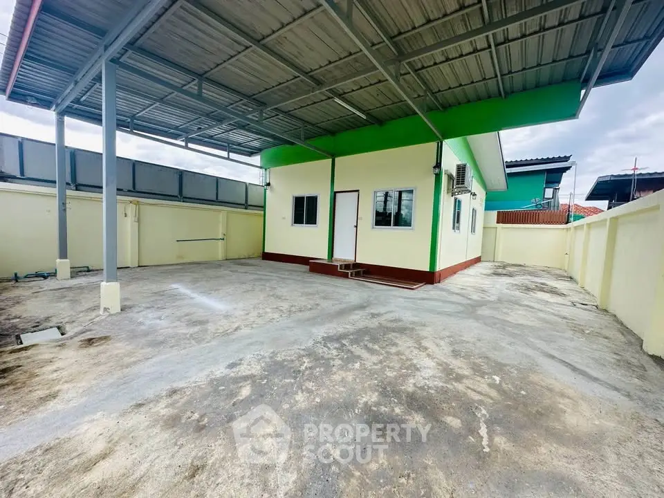 Spacious outdoor area with covered parking and modern exterior design.