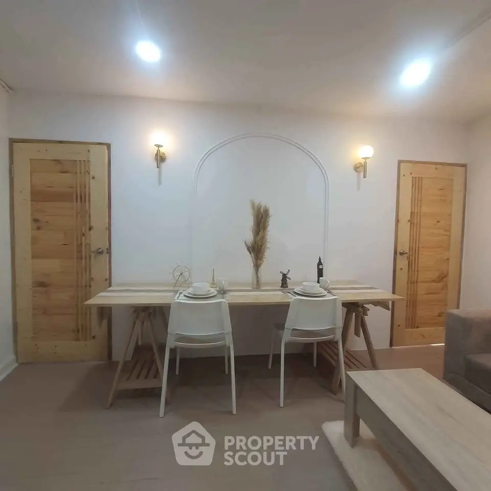 Chic dining area with modern decor and wooden accents in a cozy apartment setting.