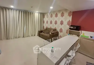 Spacious living room with modern decor and open kitchen layout, perfect for entertaining guests.