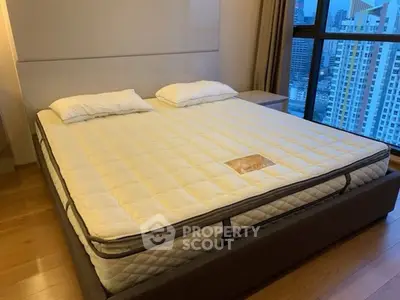 Spacious bedroom with city view and modern furnishings