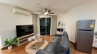 Modern living room with sleek furniture and balcony view in a stylish apartment.