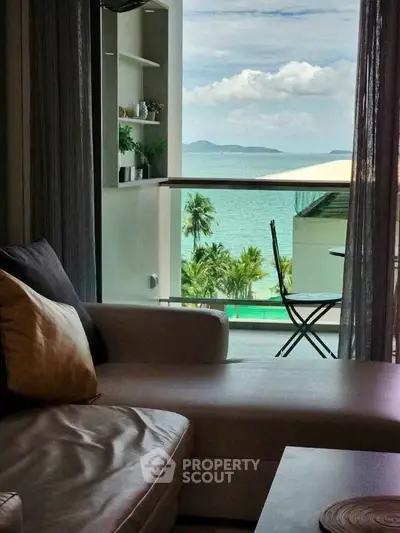 Luxurious living room with stunning ocean view and cozy seating area.